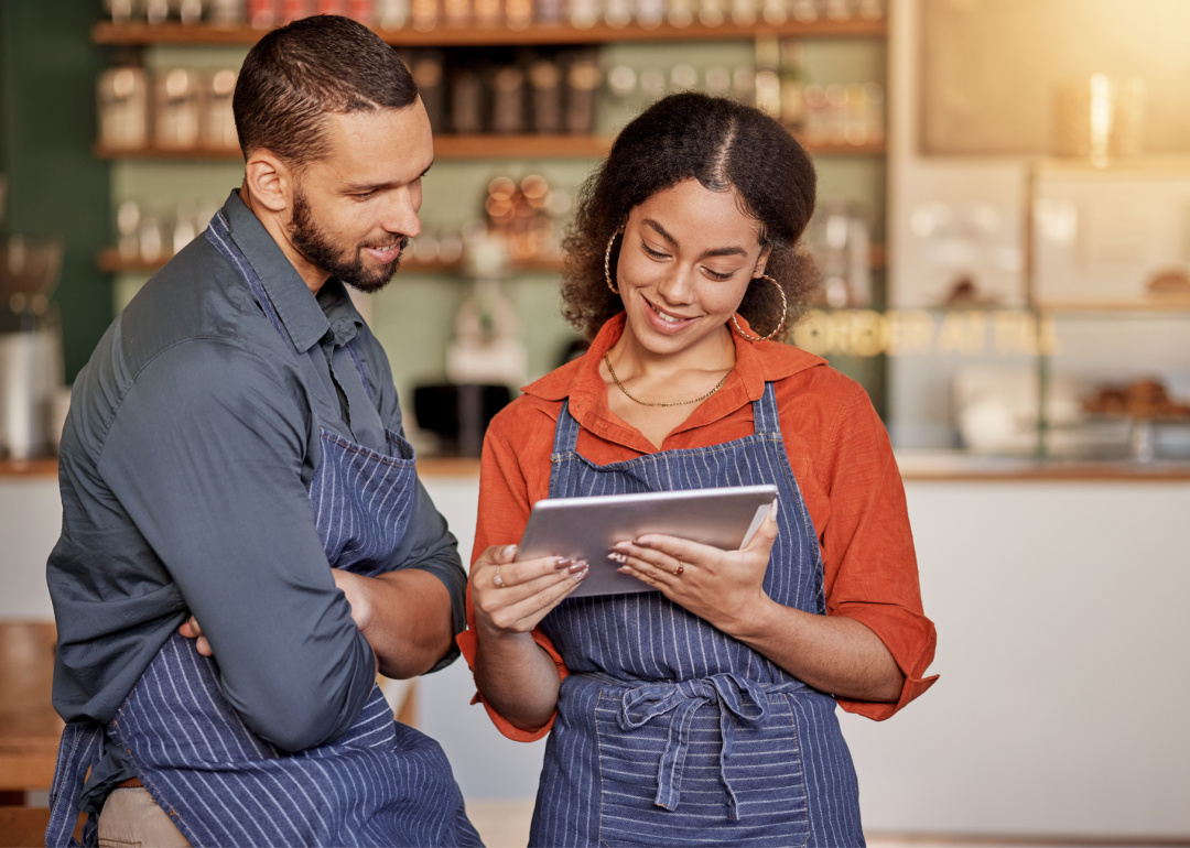 Restaurant manager and employee review schedules on tablet.