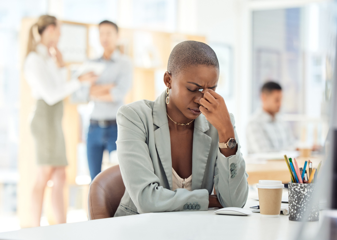 Stressed woman sitting at her desk in an office. 