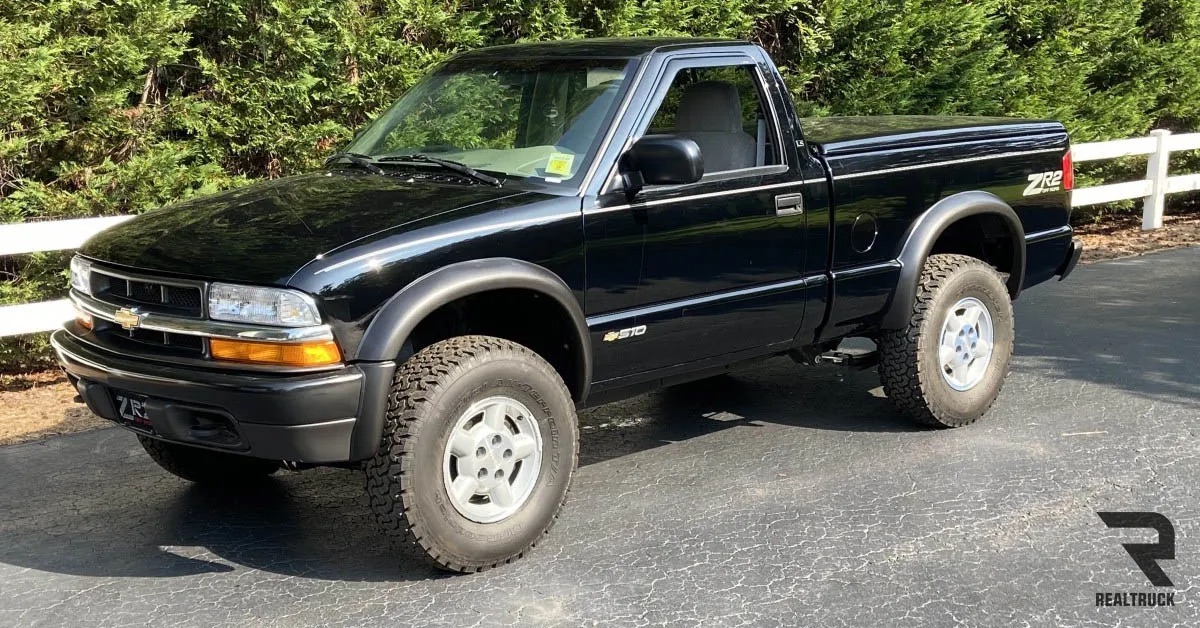 A black Chevy S10 parked on roadside.