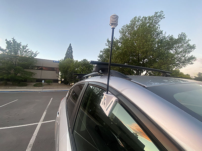 Heat mapping volunteers fit a snorkel-like sensor into their car windows, which gather temperature and humidity readings while driving their assigned routes.