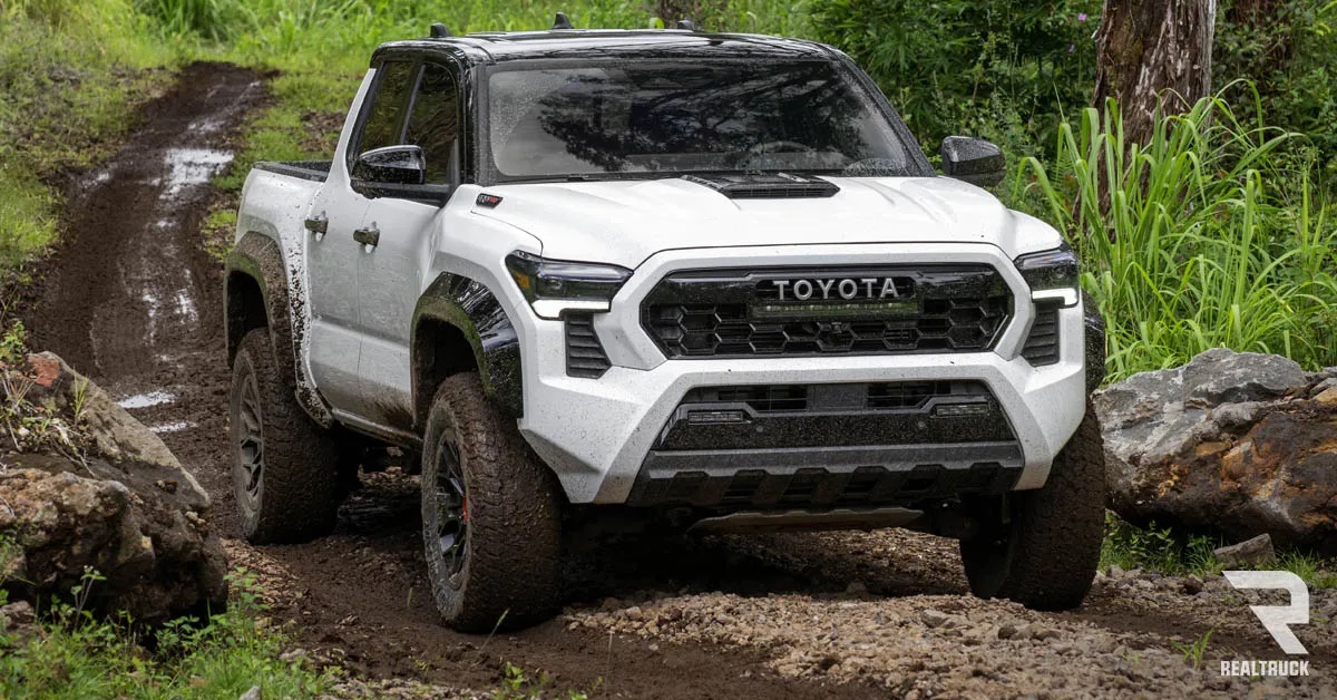 A white Toyota Tacoma TRD Pro on a muddy road.