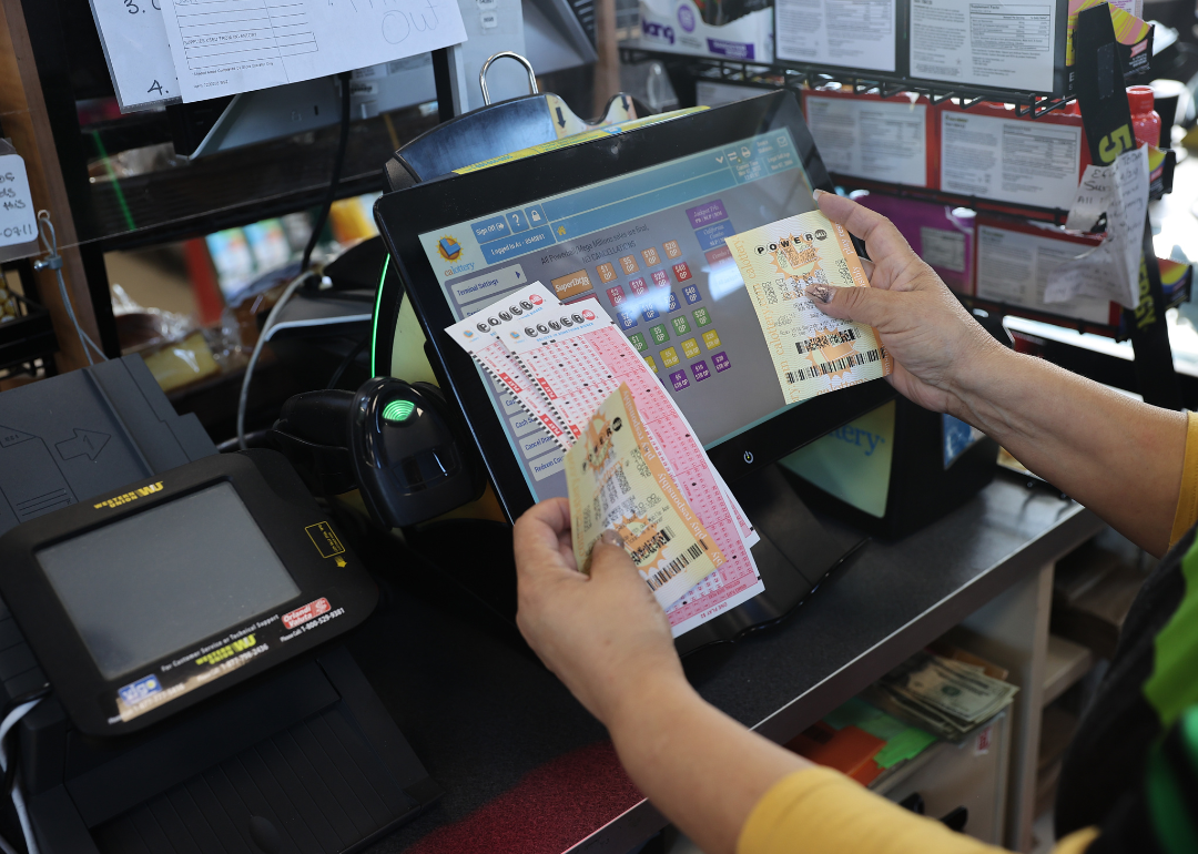 A cashier holding lottery tickets.
