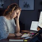 Businesswoman working on computer at night.