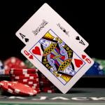 Queen and Ace cards above Blackjack table.