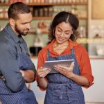 Restaurant manager and employee review schedules on tablet.