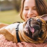 Woman holding happy dog.