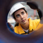 Industrial engineer wearing safety helmet in factory.