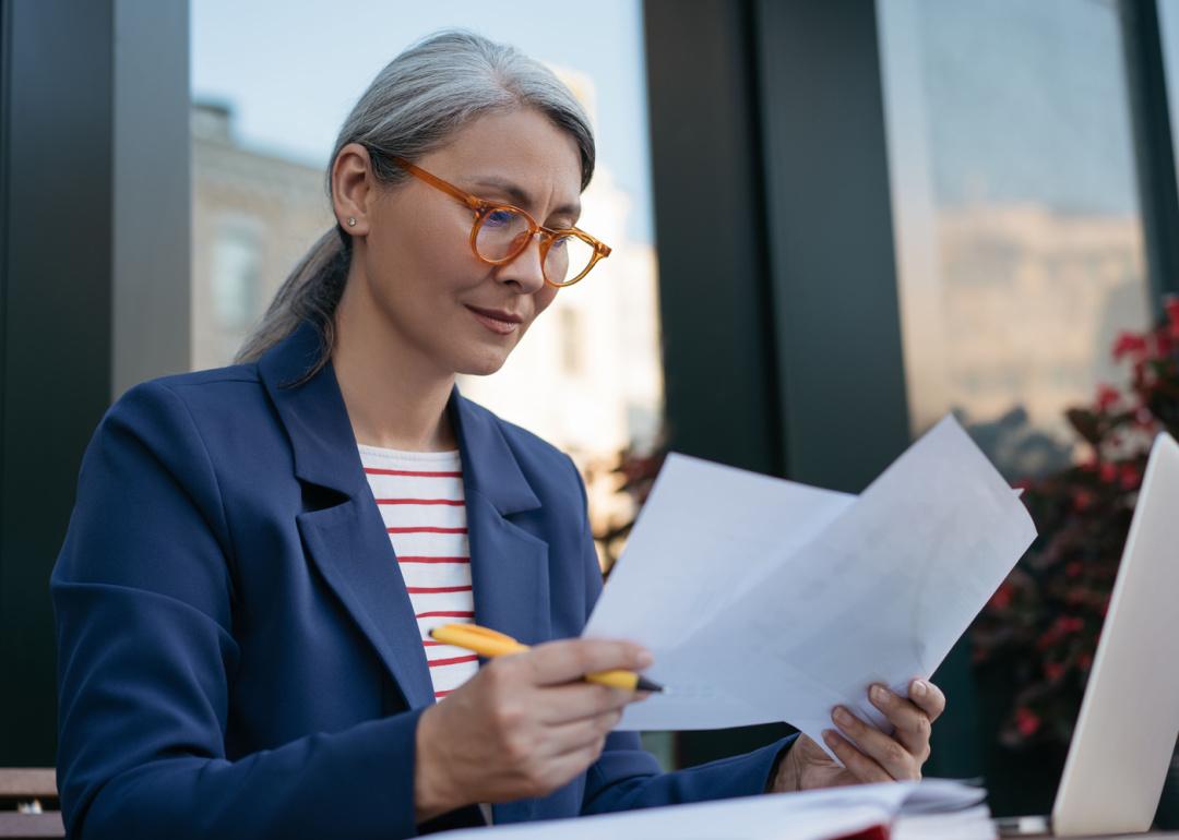 Mature businesswoman reading documents.