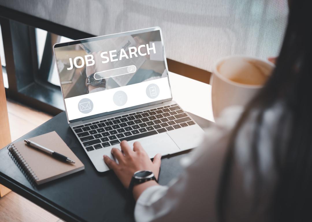 Person looking for a job on laptop