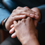 Close up of two people holding hands