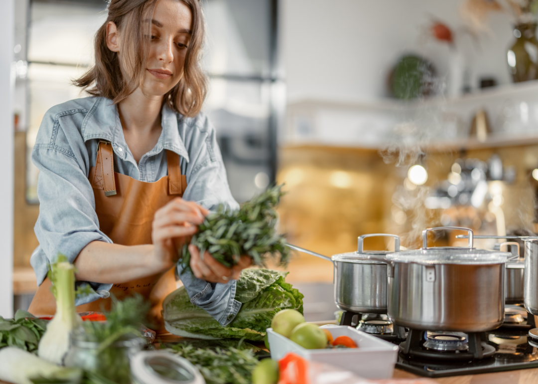Woman cooking healthy meal in kitchen.