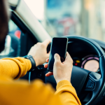 Man using mobile phone while driving.