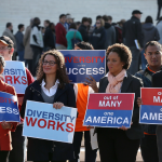 Protesters with signs in from of Supreme Court.