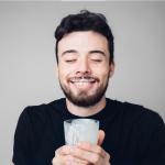 Man is drinking fresh glass of milk with a milk mustache, like the "Got milk?" ads