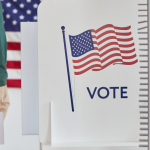 Closeup of man with ballot at polling station