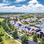Aerial view of large homes in summer.