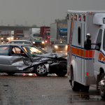 Ambulance blocks traffic after a car accident on an interstate.