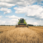 Tractor moves across dry field