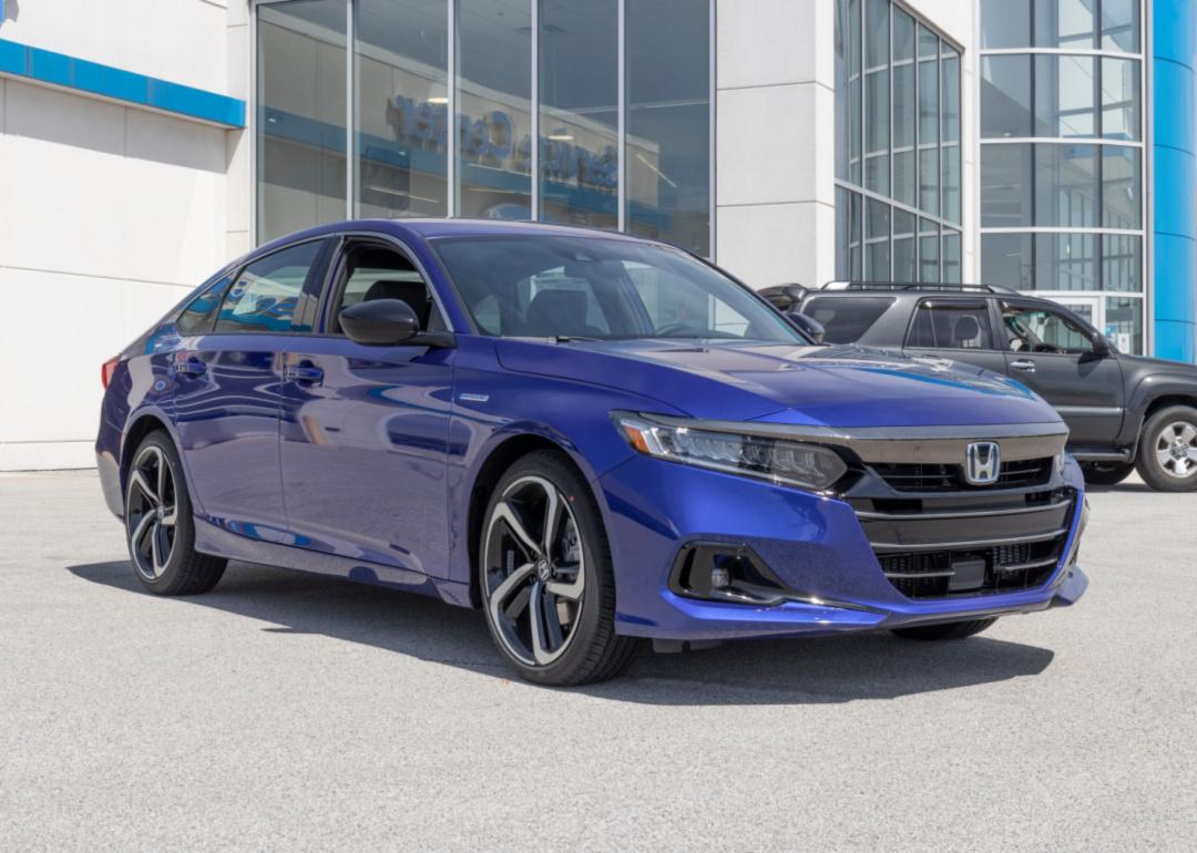 A blue Honda Accord sits in a car dealership.