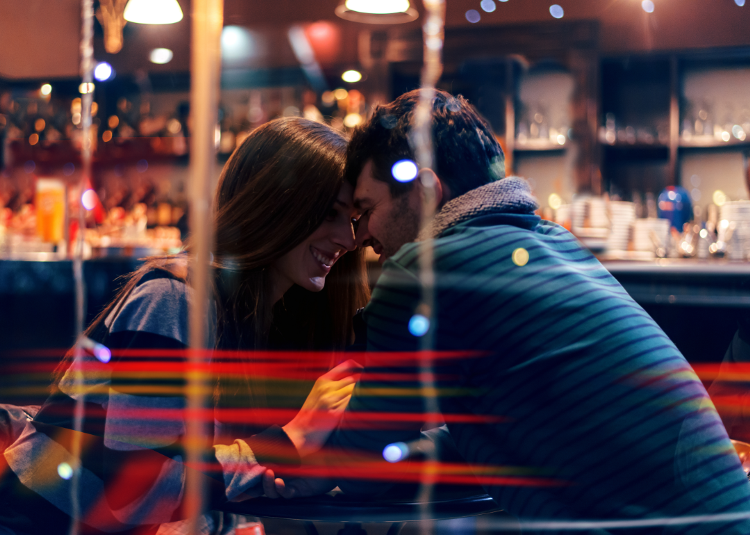 A couple on a date seen through a window.