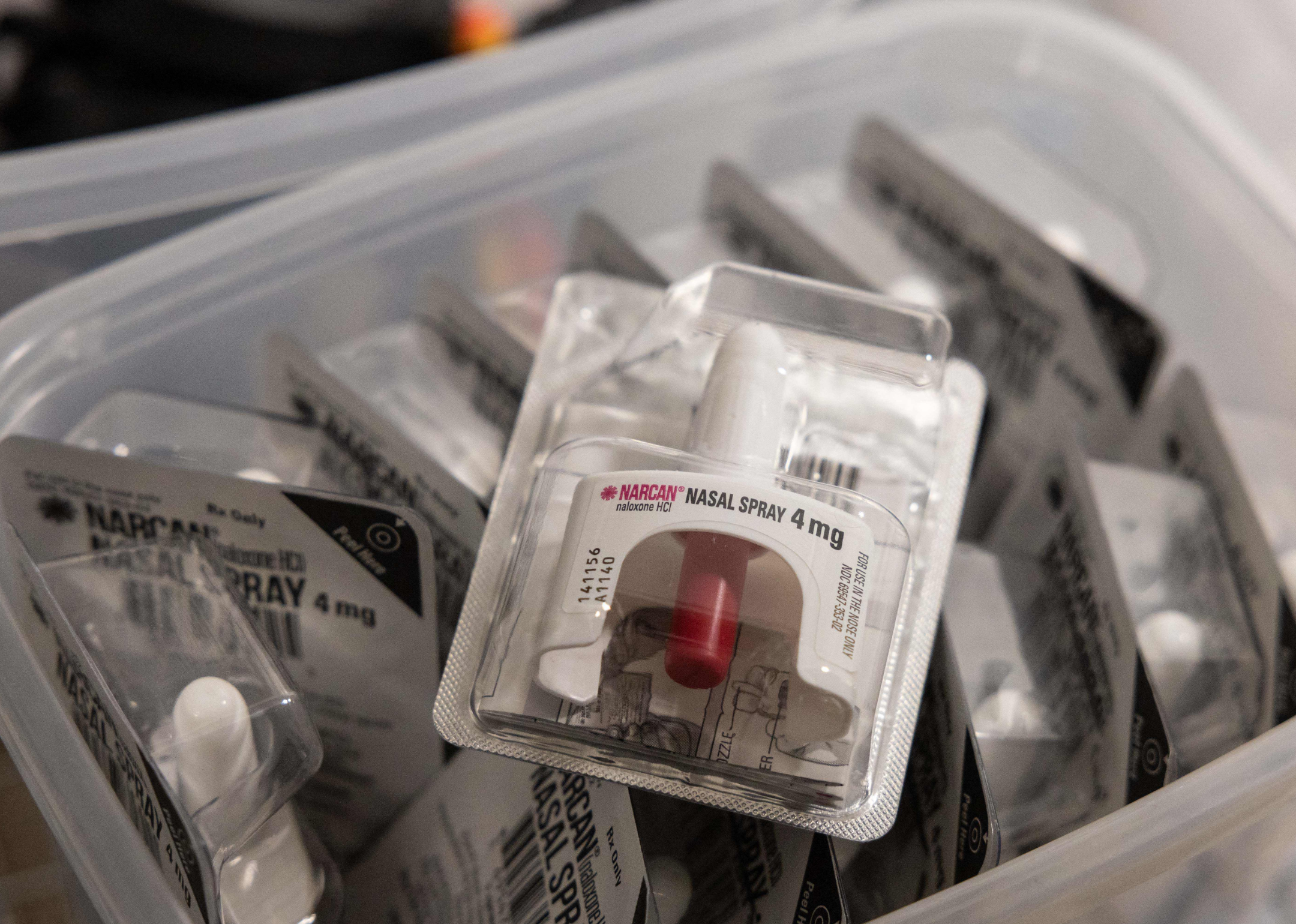 Image shows a close up of an unopened packet containing naloxone nasal spray