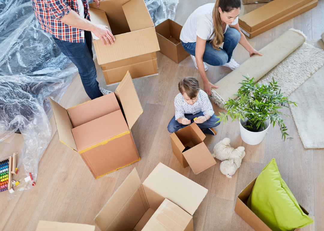 A family moving into a new home surrounded by boxes.