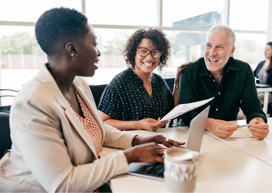 A pre-retired couple talks with their financial planner. 