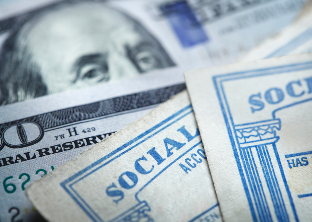 Social security cards resting on top of cash.
