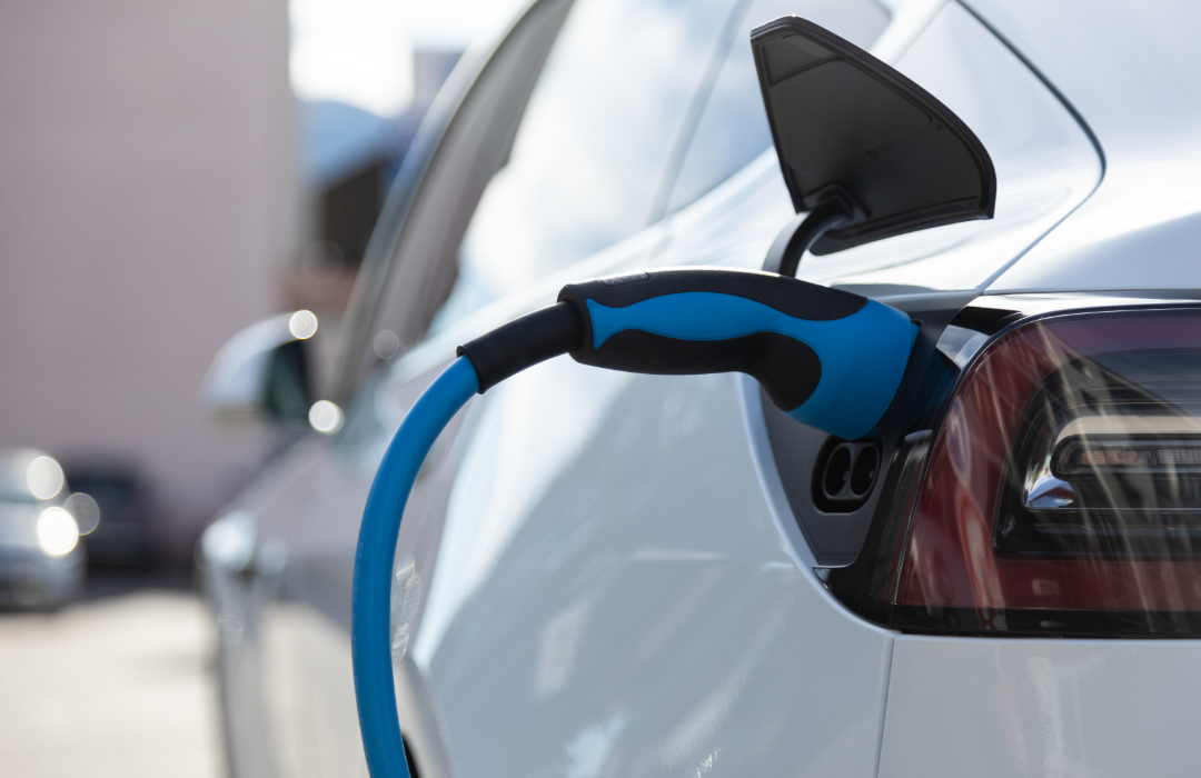 Electric vehicle charging at charging station.