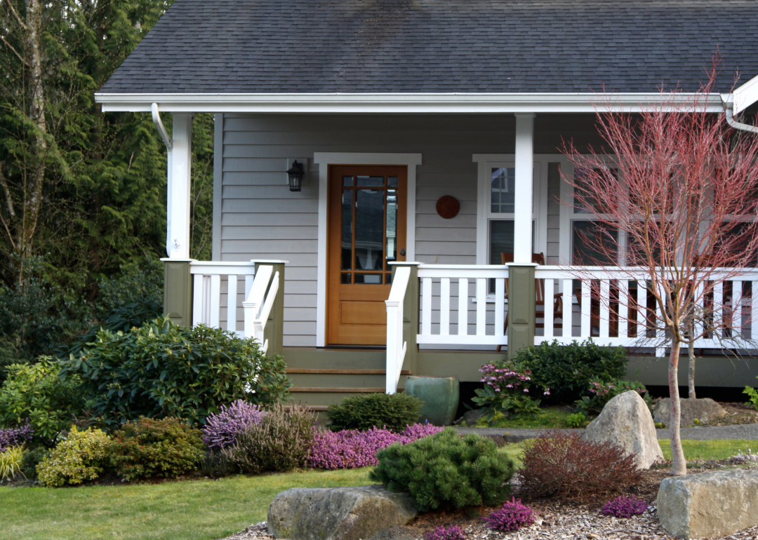 Exterior of a home with a front porch and white railing.