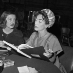  Bette Davis (L), and Joan Crawford are photographed as they look over the script of the film, What Ever Happened to Baby Jane?, in which they will co-star, circa 1962.