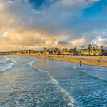 Waves in the Pacific Ocean and view of the beach at sunset, in Newport Beach, California