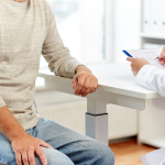 An older man consulting with a doctor