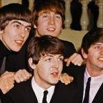 The Beatles smiling together: from left to right: George Harrison, John Lennon, Paul McCartney, and Ringo Starr.