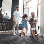 grandparent visiting children and grandchildren in nice home