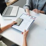 person submitting legal documents across desk