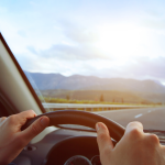 POV of driver looking at road over steering wheel