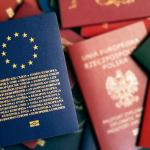 European Union blue biometric passport on background of passports of different countries