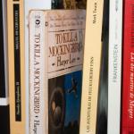 Classic books, including 'To Kill a Mockingbird' by Harper Lee and 'Jane Eyre' by Charlotte Brontë, on a shelf.