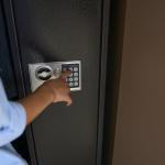 child pushing buttons on safe
