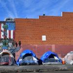 Tents for the homeless line a sidewalk in Los Angeles, California.