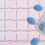 A graphic of a heart rhythm background with an overlay of blue pills.