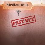 File folders of medical bills stamped with past due label