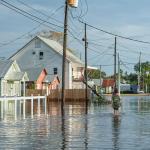Person walking on flooded Canal street in Delcambre in Louisiana during Hurricane Laura.