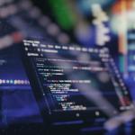 Image of a monitor displaying coding programs.