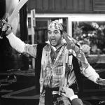 John Belushi leads the destruction wrought upon the annual homecoming parade in a scene from the 1978 college film 'Animal House.'