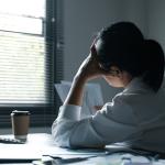 Female employee feeling stressed at work.