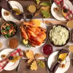 A traditional homemade Thanksgiving feast with autumnal decor.