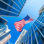 Business or finance district concept; modern buildings and the US flag.