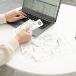 Business person entering receipt information in an expense software.